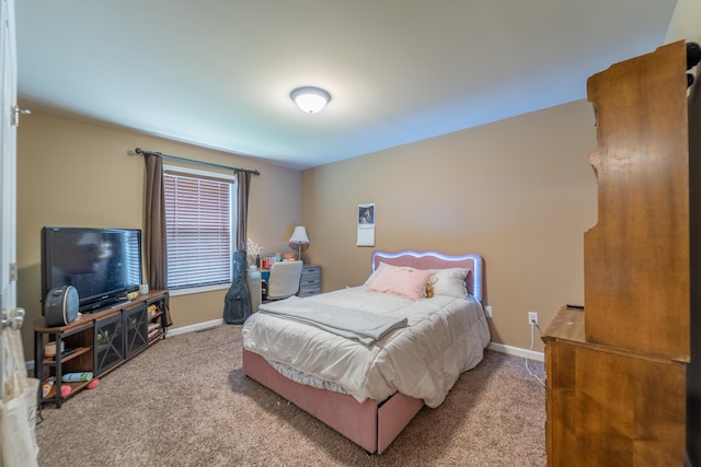 carpeted bedroom featuring baseboards