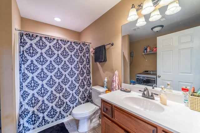 full bath with washer / clothes dryer, tile patterned floors, toilet, vanity, and curtained shower