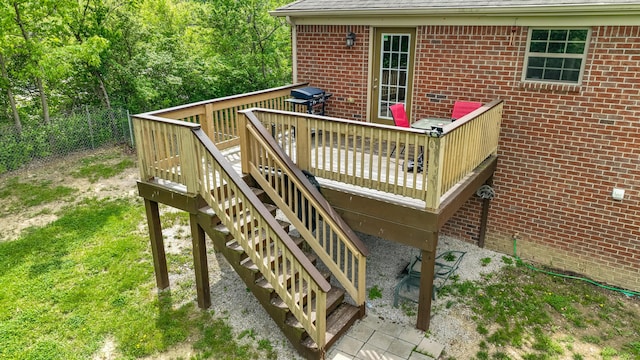 wooden terrace featuring stairs and fence