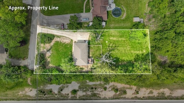 aerial view of property and surrounding area featuring property parcel outlined
