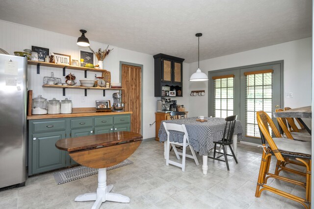 dining space with baseboards and french doors