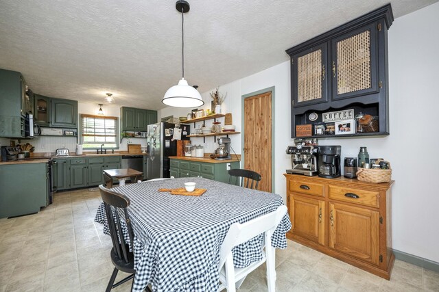 dining area featuring plenty of natural light, recessed lighting, baseboards, and a textured ceiling