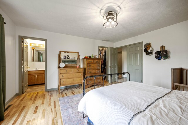 bathroom featuring toilet, a shower stall, wood finished floors, and vanity