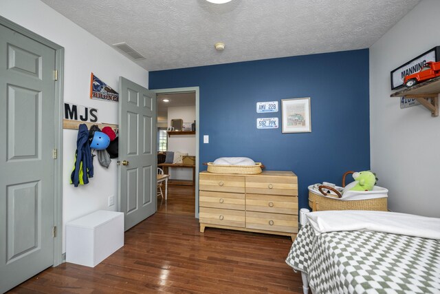bedroom featuring wood finished floors and baseboards