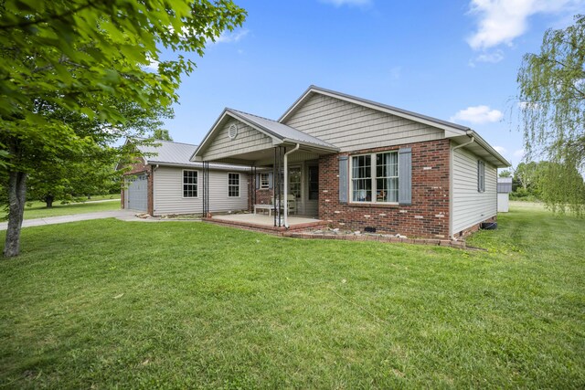 back of house with a shed, a fire pit, a lawn, and an outdoor structure