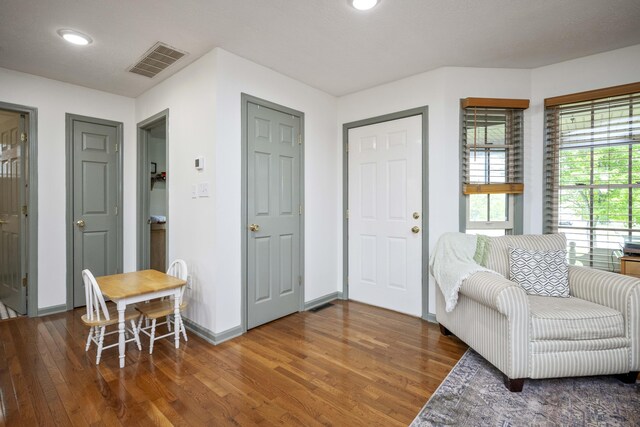living room featuring hardwood / wood-style floors, an office area, a textured ceiling, recessed lighting, and baseboards