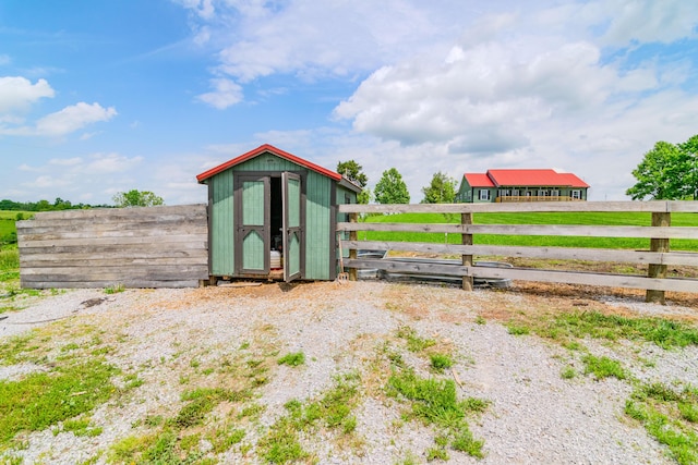 view of shed featuring fence