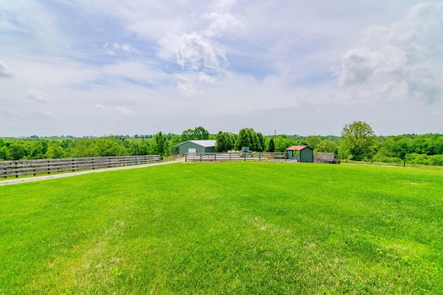 view of yard featuring a view of rural / pastoral area and an outbuilding