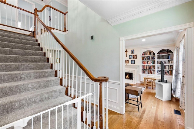 1183 The Ridings, Winchester, KY 40391 - stairs featuring ornamental molding, wood finished floors, built in shelves, and a lit fireplace