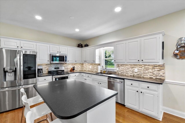 1183 The Ridings, Winchester, KY 40391 - kitchen featuring appliances with stainless steel finishes, dark countertops, a sink, white cabinetry, and recessed lighting