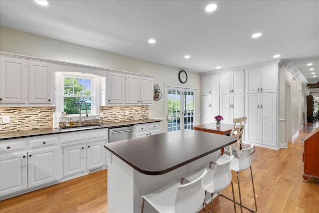 1183 The Ridings, Winchester, KY 40391 - kitchen with a sink, dark countertops, stainless steel dishwasher, a kitchen bar, and plenty of natural light