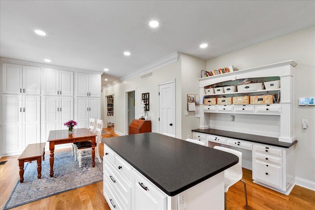 1183 The Ridings, Winchester, KY 40391 - kitchen with dark countertops, open shelves, crown molding, white cabinets, and light wood finished floors