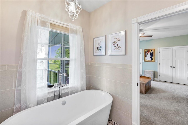 1183 The Ridings, Winchester, KY 40391 - bathroom featuring tile walls, a freestanding tub, a wainscoted wall, and ceiling fan