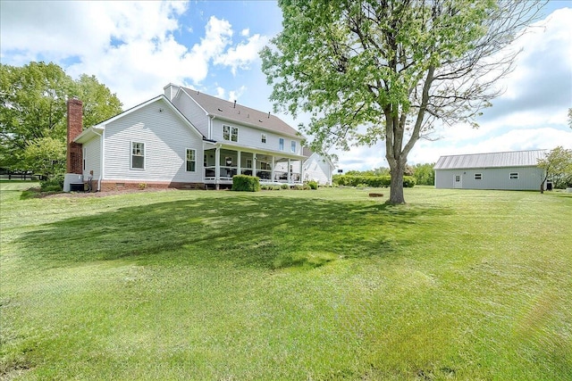 1183 The Ridings, Winchester, KY 40391 - back of house with a chimney, a lawn, cooling unit, and a sunroom
