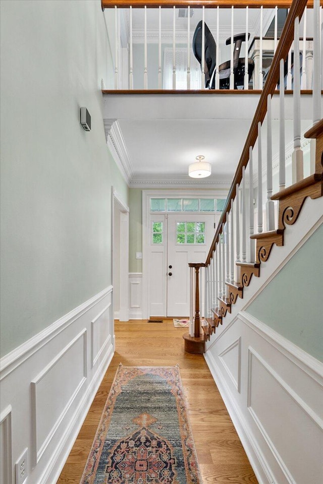 1183 The Ridings, Winchester, KY 40391 - entrance foyer with ornamental molding, stairway, a decorative wall, light wood-type flooring, and wainscoting