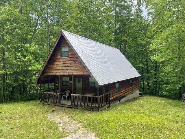 100 Buck Dr, Wellington, KY 40387 - view of front of home featuring a front lawn, crawl space, metal roof, and a wooded view