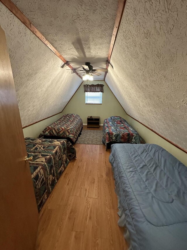 100 Buck Dr, Wellington, KY 40387 - bedroom featuring a textured ceiling, vaulted ceiling, wood finished floors, and a ceiling fan