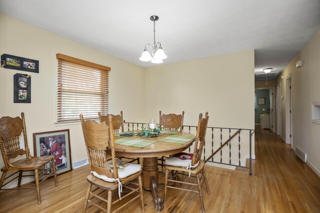 452 Rookwood Pkwy, Lexington, KY 40505 - dining area with light wood-type flooring, a chandelier, and attic access