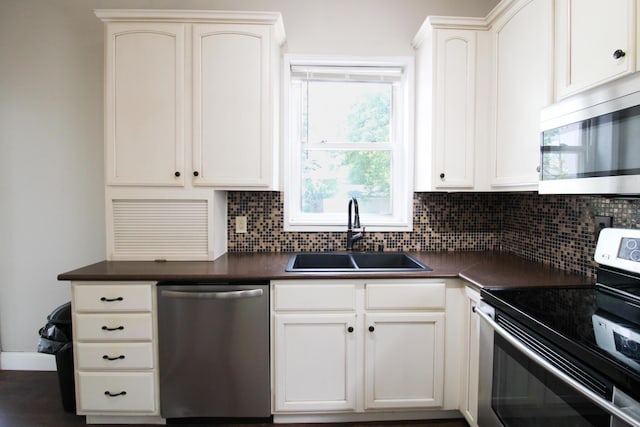 50 Sterling Ave, Fort Thomas, KY 41075 - kitchen featuring stainless steel appliances, a sink, dark countertops, and backsplash