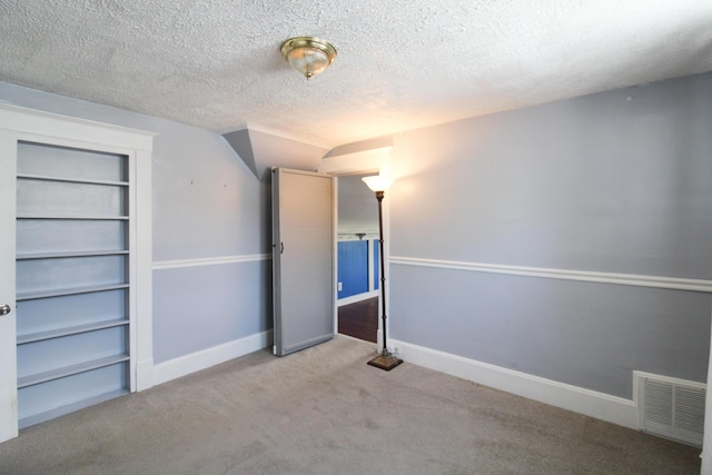50 Sterling Ave, Fort Thomas, KY 41075 - unfurnished bedroom with carpet, a textured ceiling, baseboards, and lofted ceiling