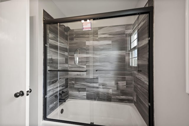 bathroom featuring shower / bath combination with glass door