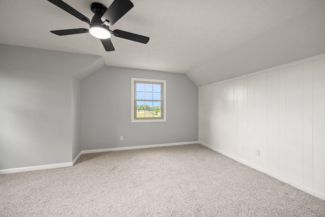 bonus room featuring carpet, lofted ceiling, ceiling fan, and baseboards