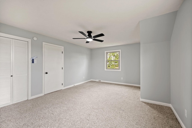 unfurnished bedroom featuring carpet, baseboards, and ceiling fan
