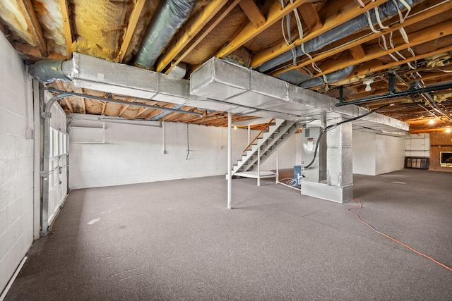 unfinished below grade area with concrete block wall and stairs