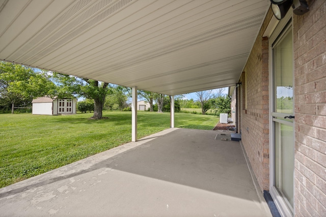 view of patio featuring a shed and an outdoor structure