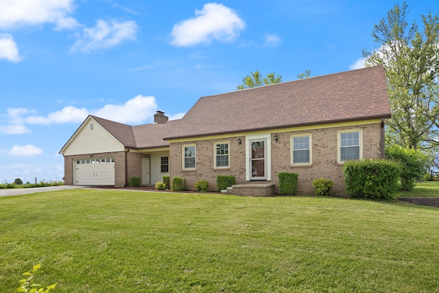 view of front of house featuring brick siding, driveway, a front lawn, an attached garage, and a chimney