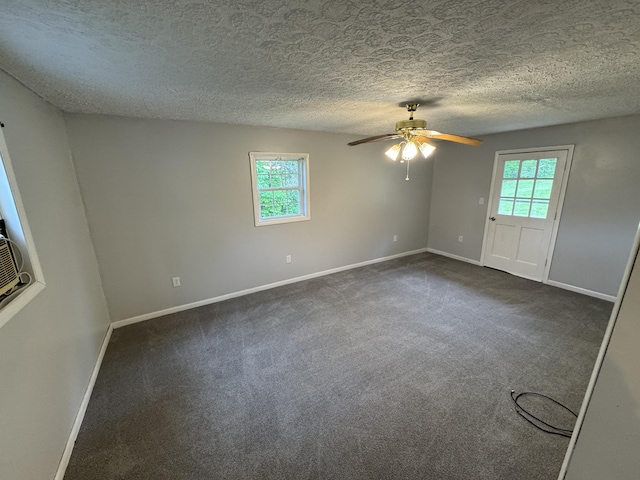 357 Powell Rd, Clay City, KY 40312 - spare room with healthy amount of natural light, baseboards, a ceiling fan, dark carpet, and a textured ceiling