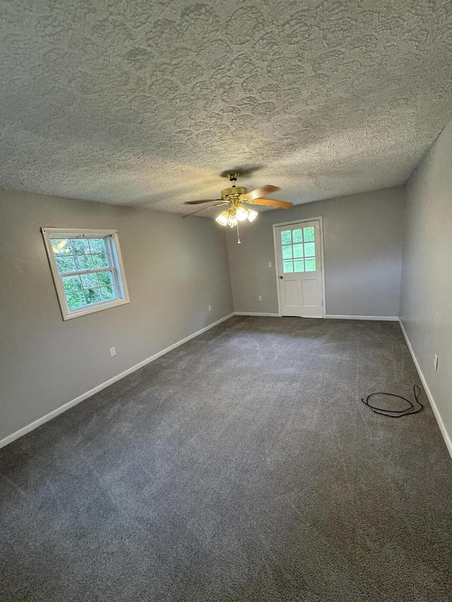 357 Powell Rd, Clay City, KY 40312 - spare room with ceiling fan, dark carpet, baseboards, and a textured ceiling
