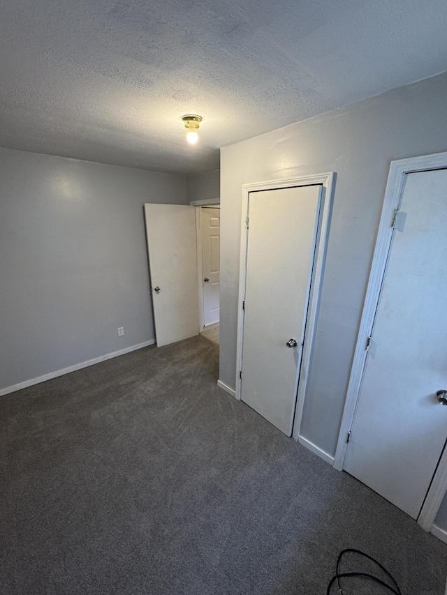 357 Powell Rd, Clay City, KY 40312 - unfurnished bedroom featuring dark colored carpet, a textured ceiling, and baseboards