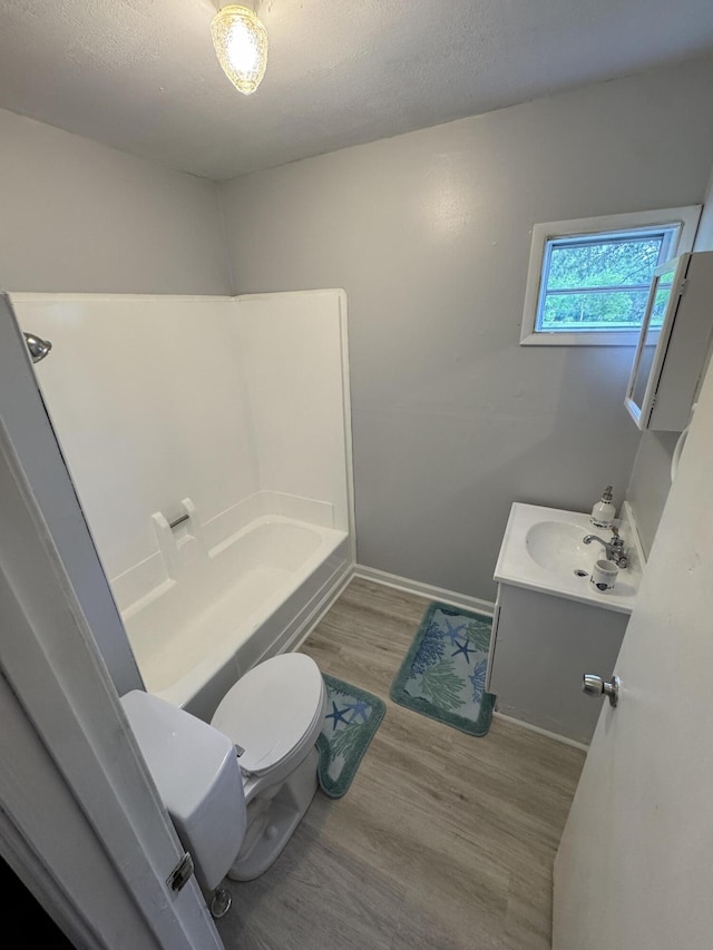 357 Powell Rd, Clay City, KY 40312 - bathroom featuring toilet, wood finished floors, vanity, baseboards, and a textured ceiling