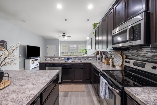 157 Cross Park Dr, Georgetown, KY 40324 - kitchen featuring appliances with stainless steel finishes, a sink, light wood-type flooring, a ceiling fan, and backsplash
