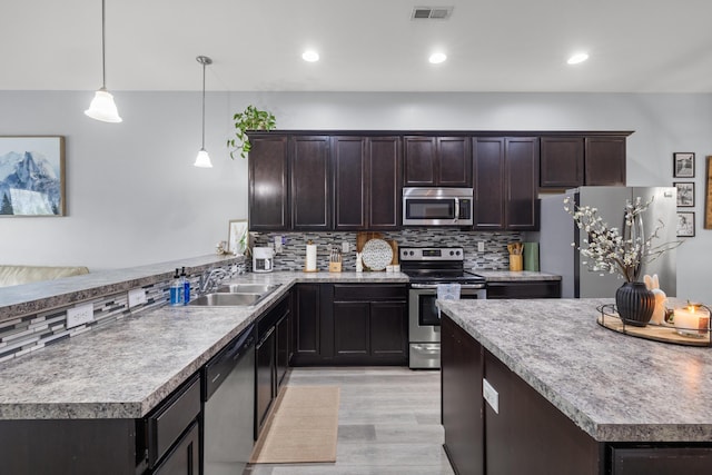 157 Cross Park Dr, Georgetown, KY 40324 - kitchen featuring stainless steel appliances, a sink, light wood finished floors, dark brown cabinets, and recessed lighting