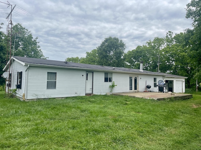1038 Levy Rd, Paris, KY 40361 - back of house featuring a patio, a lawn, and a garage
