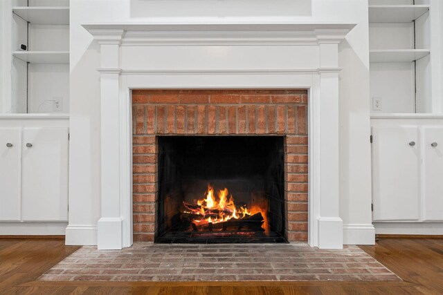 303 Patchen Dr, Lexington, KY 40517 - detailed view of a brick fireplace, wood finished floors, and baseboards