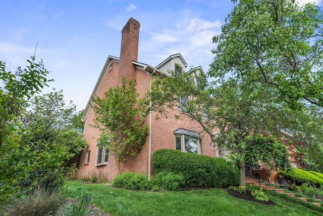 303 Patchen Dr, Lexington, KY 40517 - view of property exterior with brick siding and a chimney