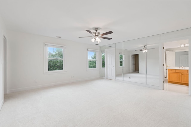 303 Patchen Dr, Lexington, KY 40517 - unfurnished bedroom featuring light carpet, baseboards, ceiling fan, and connected bathroom
