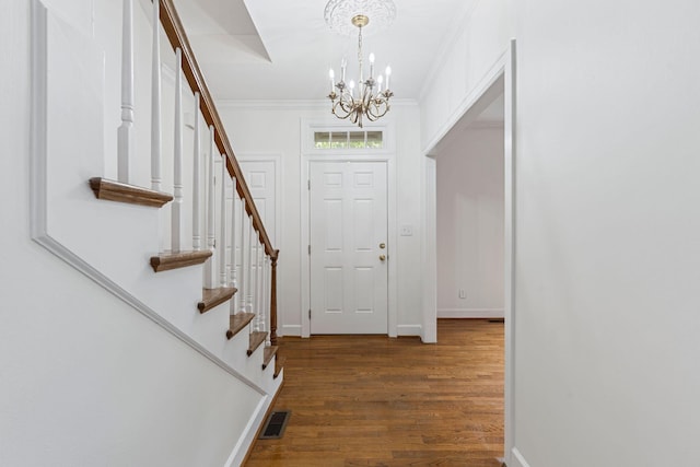 303 Patchen Dr, Lexington, KY 40517 - entrance foyer with a chandelier, wood finished floors, stairs, ornamental molding, and baseboards
