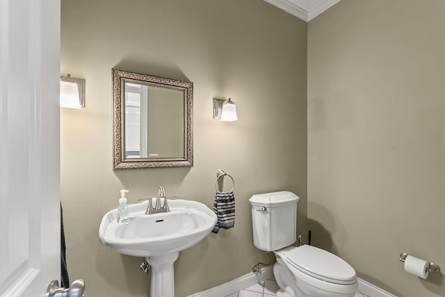 half bath featuring toilet, ornamental molding, baseboards, and tile patterned flooring