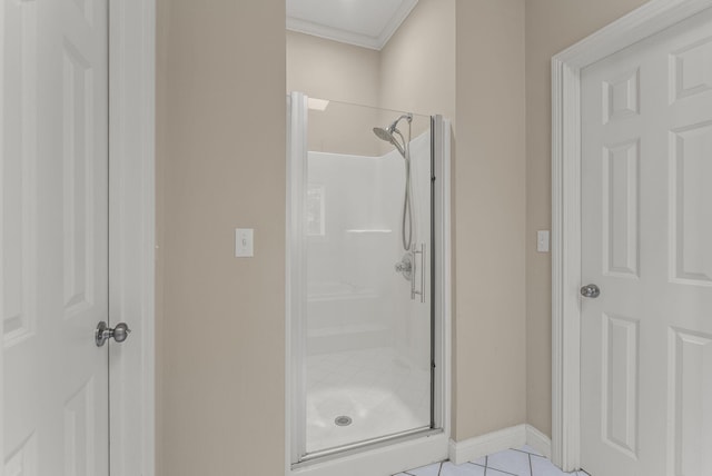 bathroom featuring a stall shower, tile patterned flooring, and baseboards