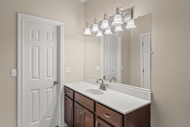 bathroom featuring a chandelier and vanity