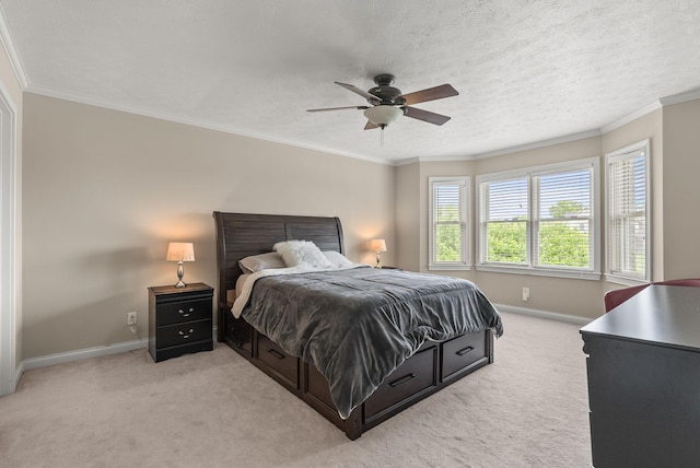 bedroom featuring light colored carpet, baseboards, a ceiling fan, and ornamental molding