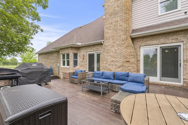 deck featuring an outdoor living space, area for grilling, and fence