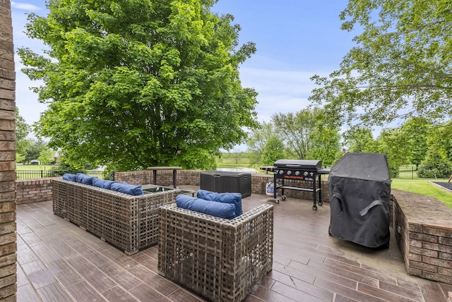 view of patio with an outdoor living space, grilling area, and fence