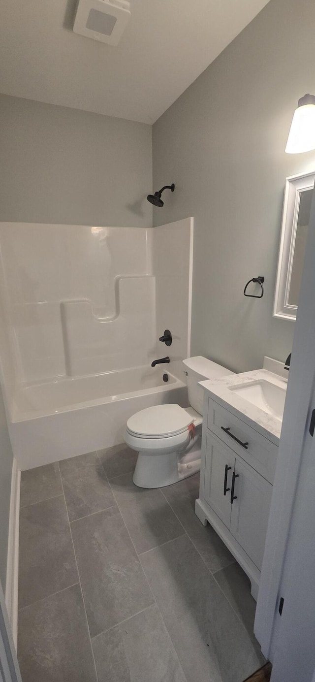 full bathroom featuring bathtub / shower combination, toilet, vanity, and tile patterned flooring