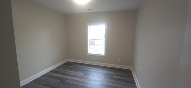 unfurnished room featuring dark wood finished floors and baseboards