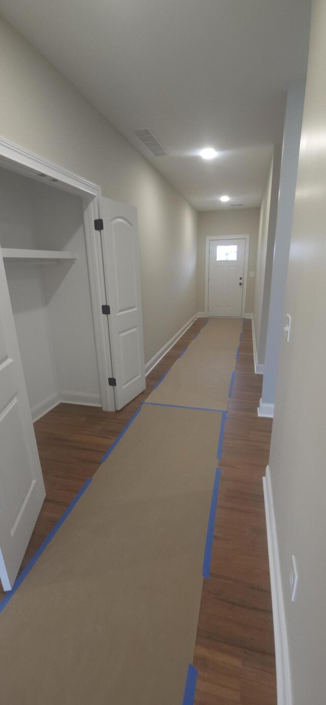 hall with wood finished floors and baseboards